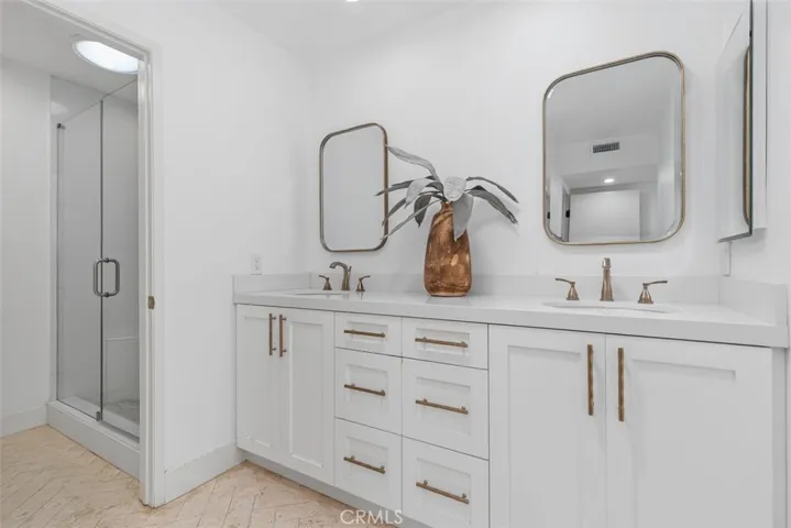 Remodeled master bathroom with dual vanities and walk in shower.