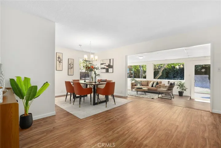 Great perspective of the massive dining area and drop down family room with an abundance of windows and natural light flooding in!