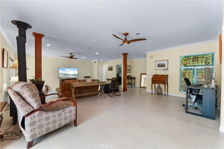 open grand room with outdoor views and deck