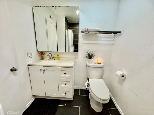HIgh tech bathroom with tiled walk in shower.