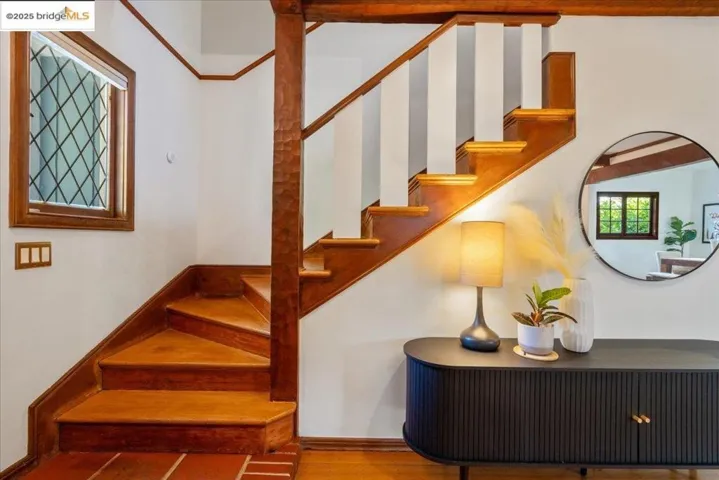 Staircase with wood finished floors and baseboards