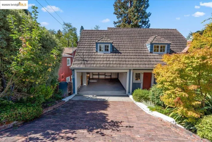 View of front of house featuring decorative driveway and board and batten siding