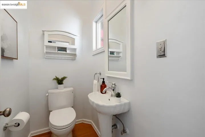 Bathroom with toilet and wood finished floors