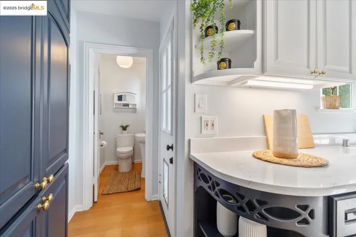 Interior space featuring light wood-style flooring and toilet