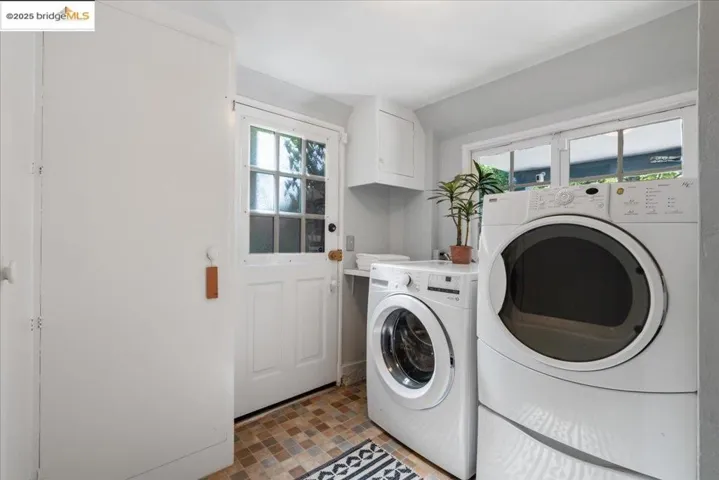 Laundry room with cabinet space and independent washer and dryer