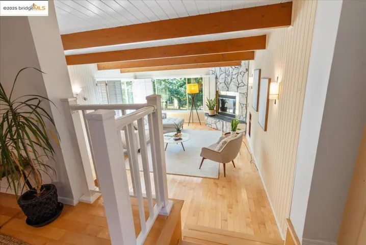 Hallway featuring hardwood / wood-style floors and beam ceiling