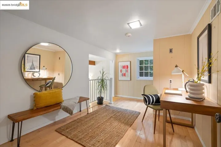Office with ornamental molding and light wood finished floors