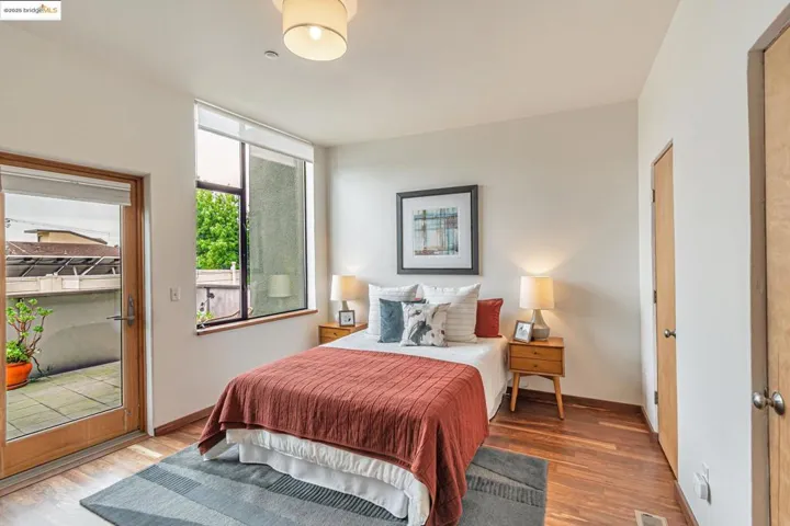 Primary Suite with wood finished floors, walk-in closet and access to private balcony.