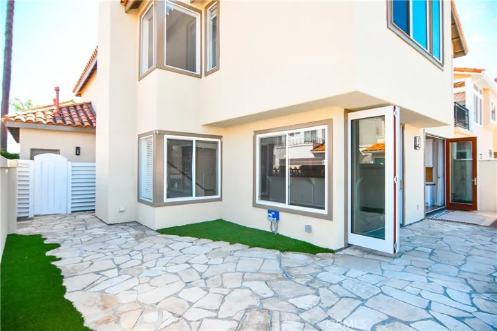 wrap around patio with some artificial grass