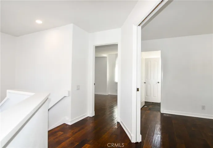 top of stairs , entrances to guest bedrooms , opposite side of home from primary suite