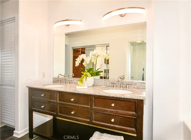 custom granite counter and modern lighting in primary suite