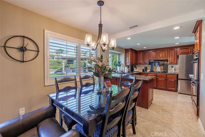 Looking into the breakfast nook area with the kitchen in the background