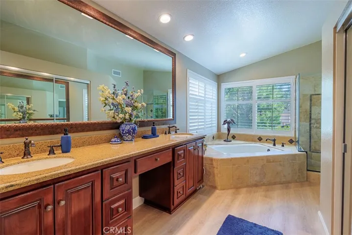 Fully remodeled en-suite bath with double-sink vanity, deep soaking tub and separate shower. There's also a huge walk-in closet