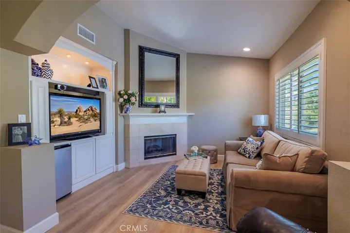 Stepping into the retreat area with fireplace and large built-in cabinetry for television and storage
