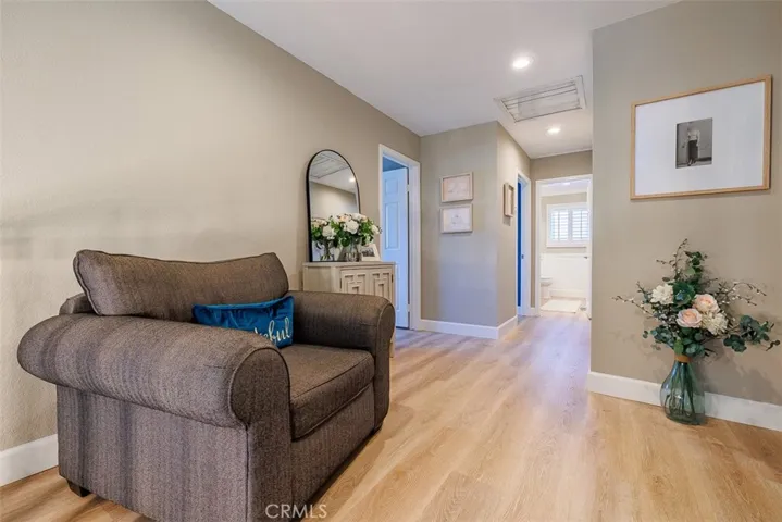 Top of the stairs view of owner-added sitting area. Newer laminate flooring is in all of the upstairs rooms