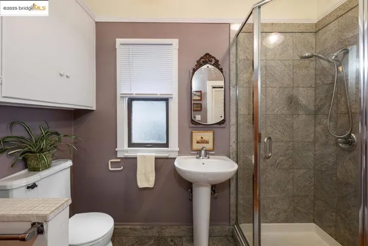 Full bath with a stall shower and toilet