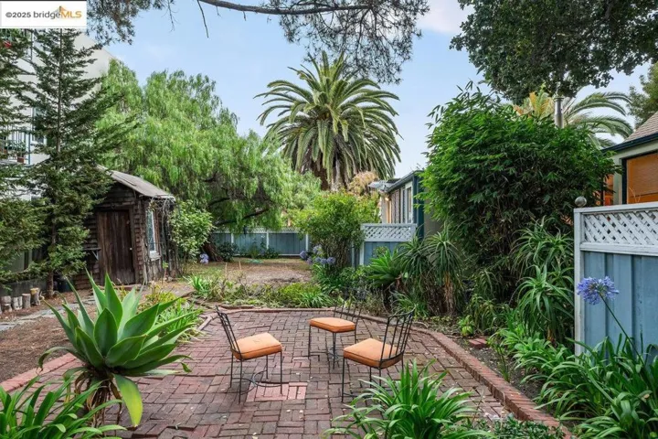 Fenced backyard with a patio area and a shed
