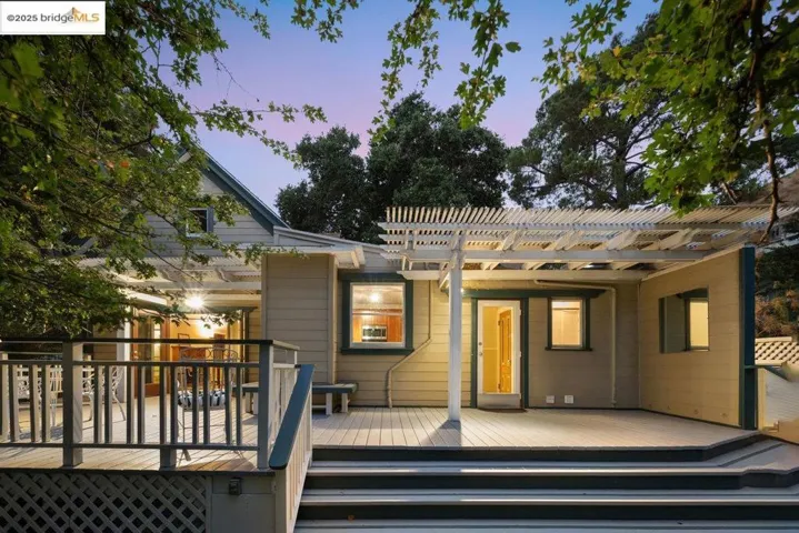 Back of house featuring a wooden deck