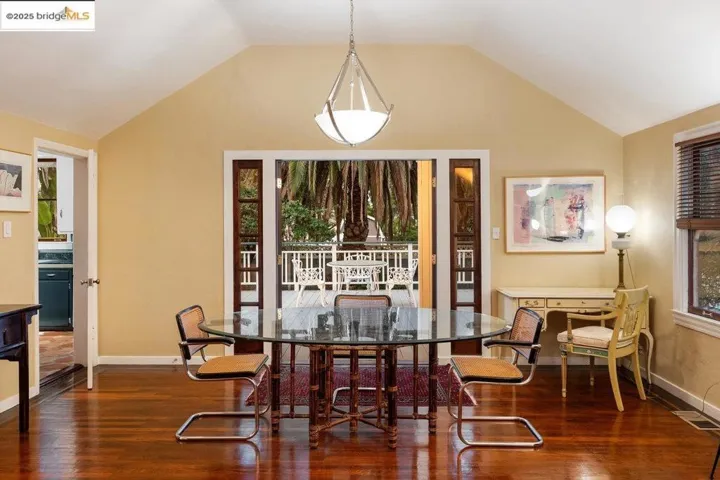 Dining room with wood finished floors and lofted ceiling