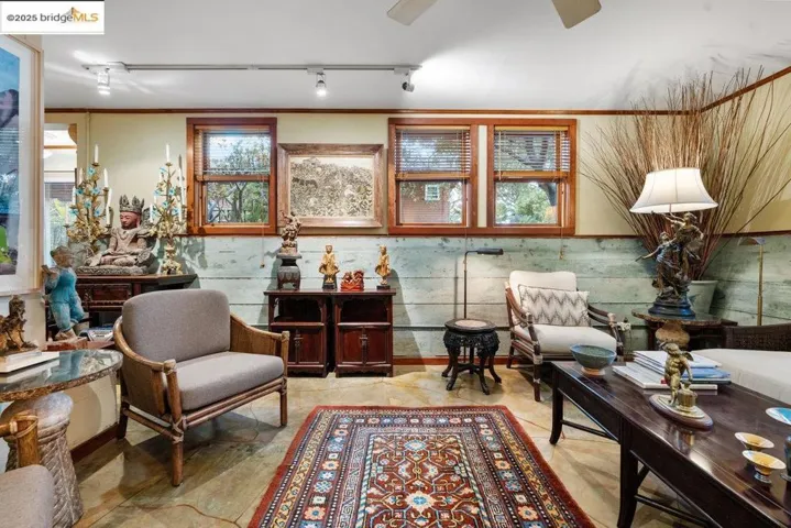 Sitting room with rail lighting and ornamental molding