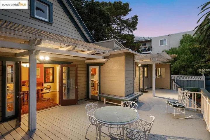 Deck featuring a pergola and outdoor dining area