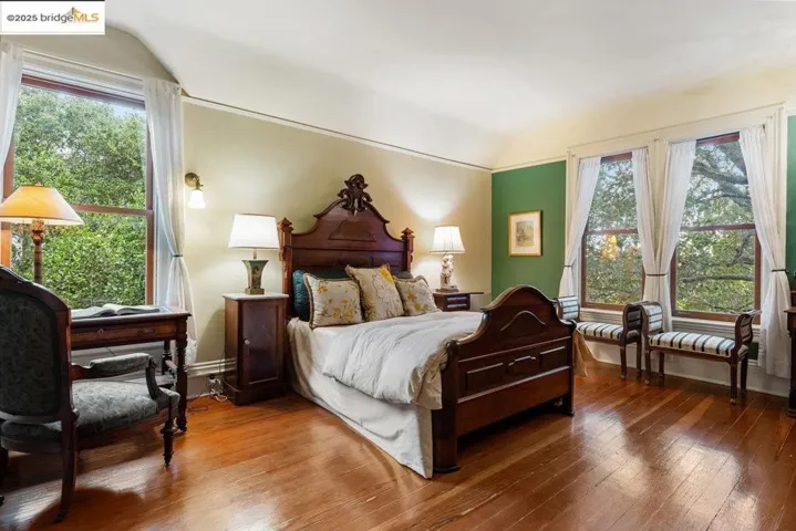 Bedroom with wood-type flooring and vaulted ceiling