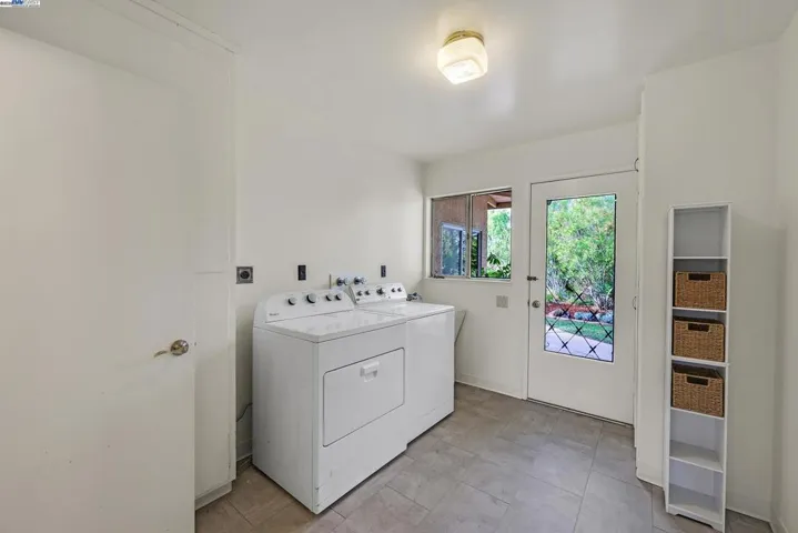 Large laundry room with wash sink, washer dryer and half bath.