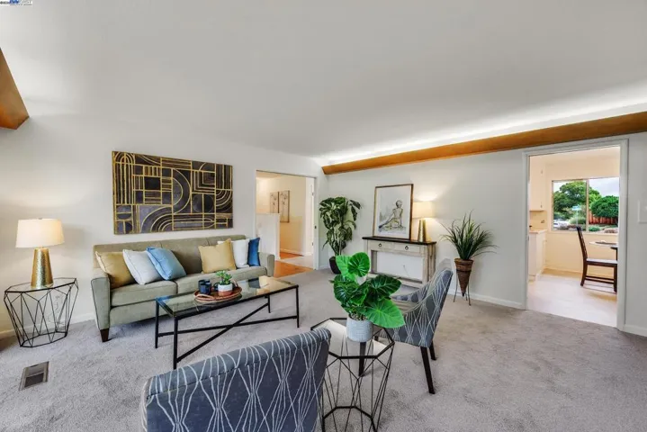 Family room with access to kitchen and living room. Up lighting at ceiling provides ambiance and character from the 1960's.