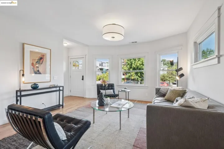 Living room with healthy amount of natural light and light wood finished floors