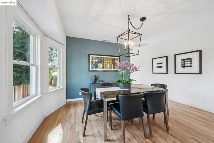 Dining room with light wood finished floors and a chandelier