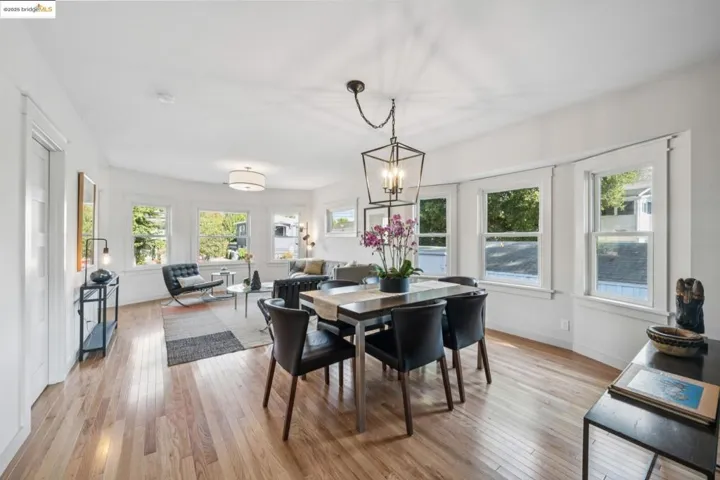 Dining space with light wood-style flooring and a chandelier