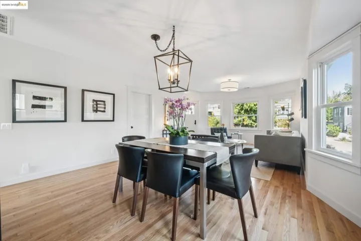 Dining room with light wood-type flooring and a chandelier