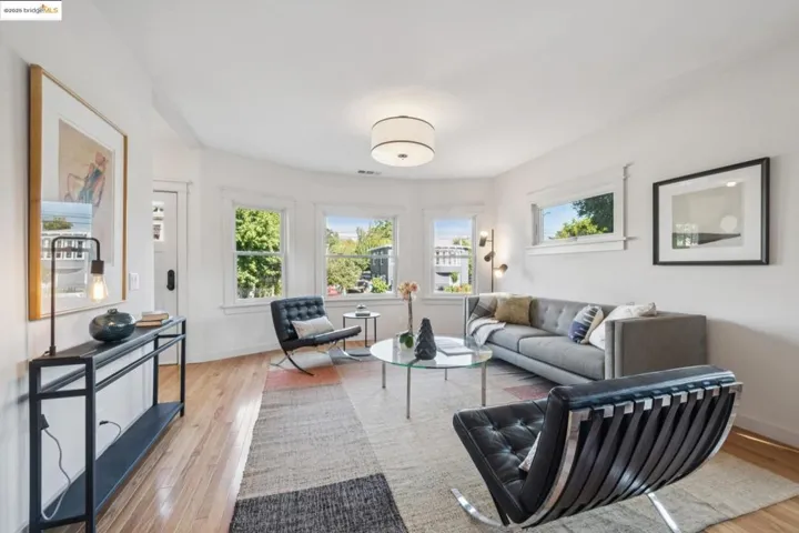 Living room with light wood-type flooring and baseboards