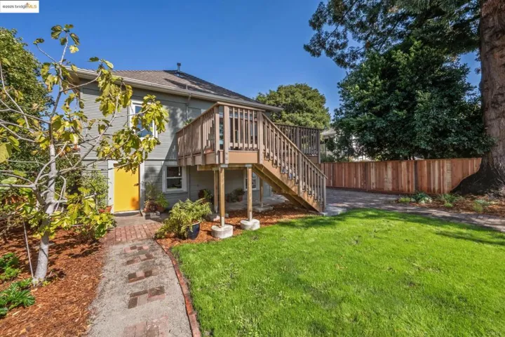 Back of house featuring stairs and a deck