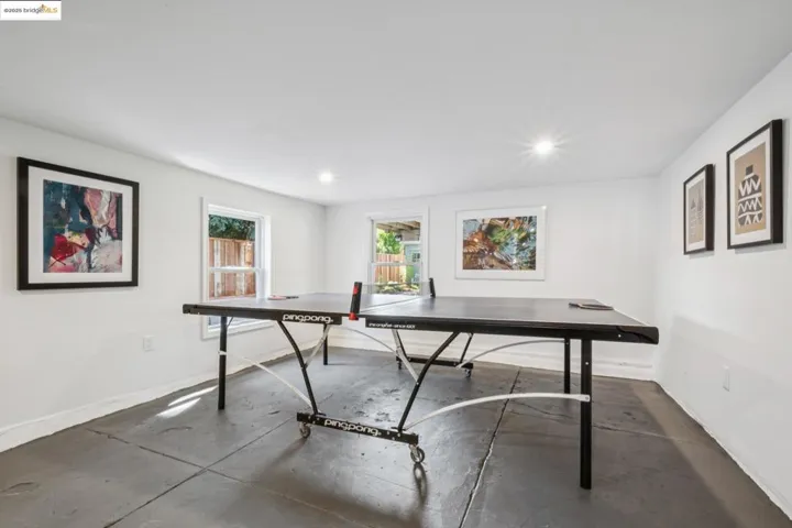 Game room with concrete flooring and recessed lighting