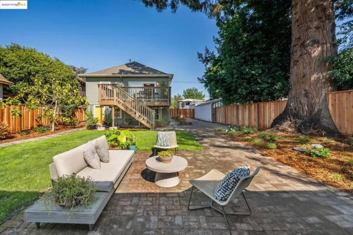 Fenced backyard with a patio, stairway, outdoor lounge area, and a deck