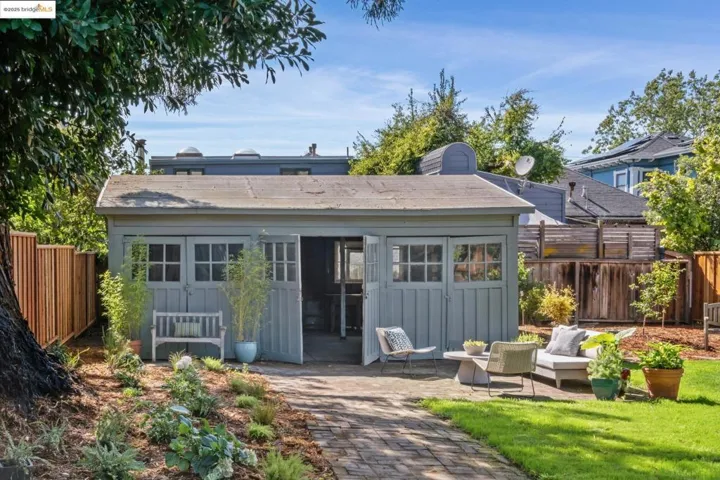 Rear view of house with a fenced backyard and a patio