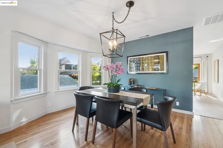 Dining area with light wood finished floors and a chandelier