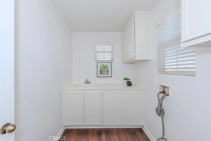 Laundry room with sink and cabinets