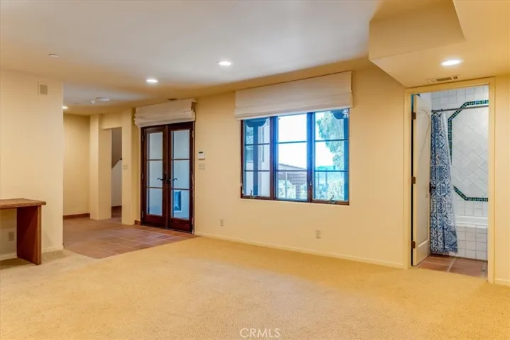French doors to the outside from entertainment room.  Full bath on the right; attached to bedroom.