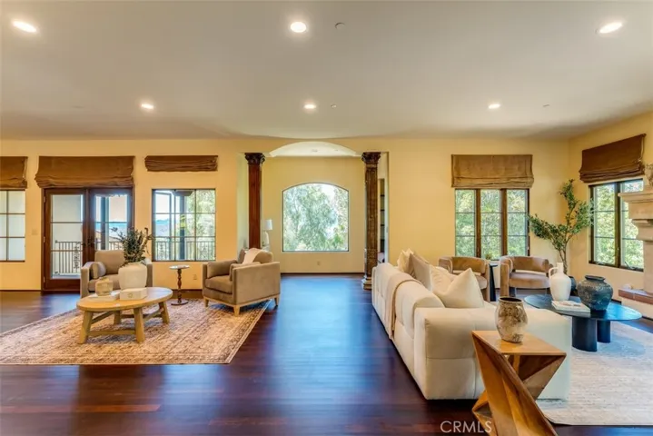 View from the entry foyer.  The arched window highlights a cozy nook with built-in seating and book shelves.  To the left is the balcony off the main living area with wonderful city and mountain views.