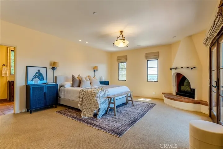 Primary suite with fireplace and doors to view deck.