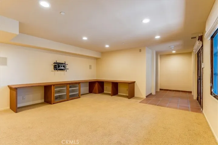 Entertainment room on lower level.  The wine cellar is in the far back to the left.