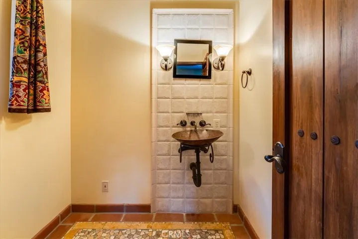 Powder room off entry foyer.