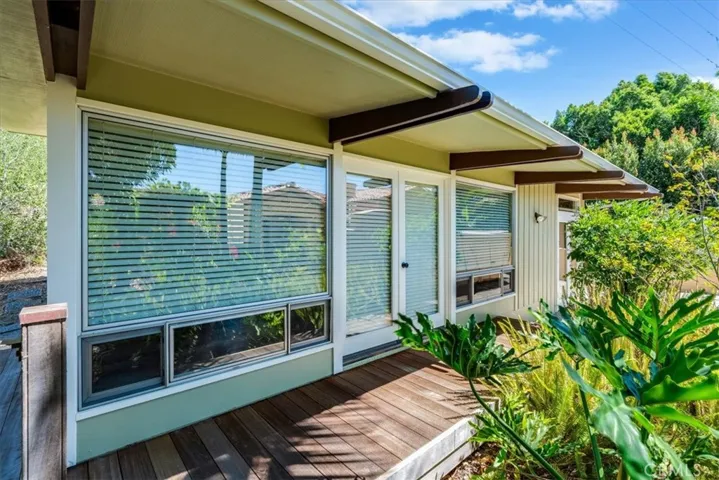 Left to right:  Living room window, front doors, kitchen window.