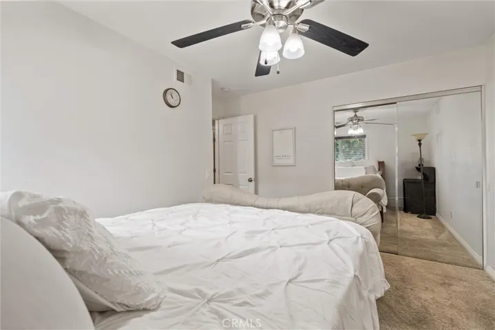 Second upstairs bedroom with ceiling fan.