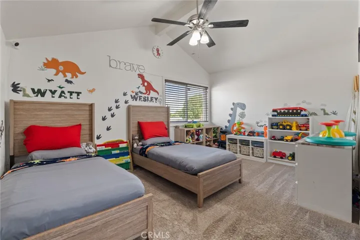 Large upstairs bedroom with ceiling fan.