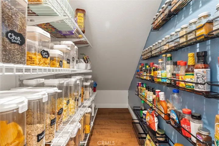 Walk in pantry with built in storage racks for easy storage and organization.
