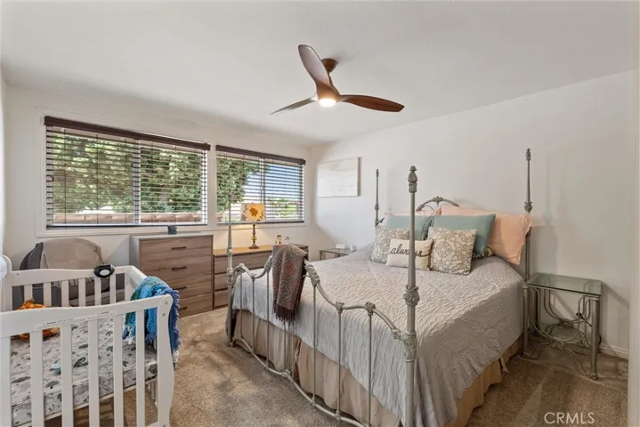 Primary bedroom with lots of natural light and ceiling fan.