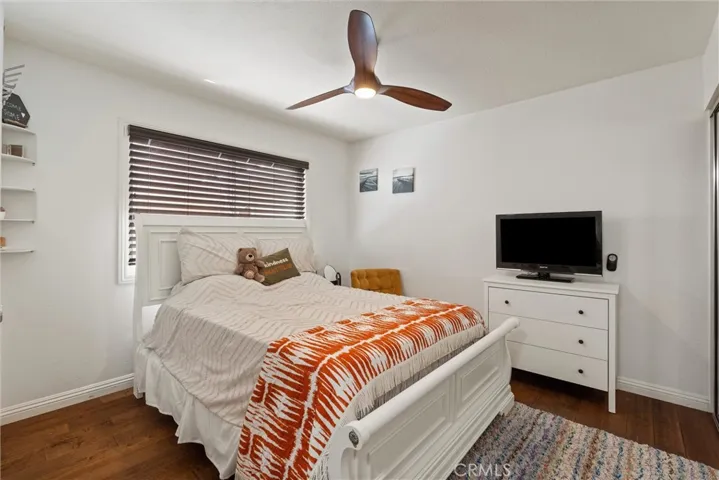 Downstairs bedroom with ceiling fan. Can be utilized by private side entrance.